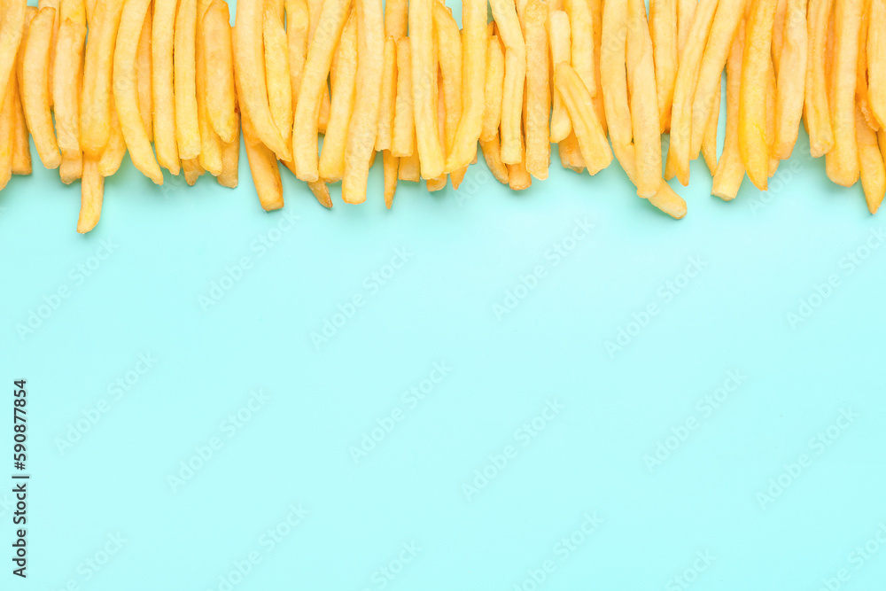 Tasty french fries on light blue background