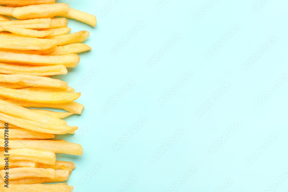 Tasty french fries on light blue background