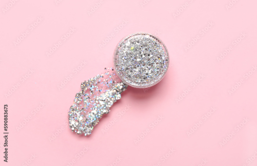 Jar of silver glitter with stroke on pink background