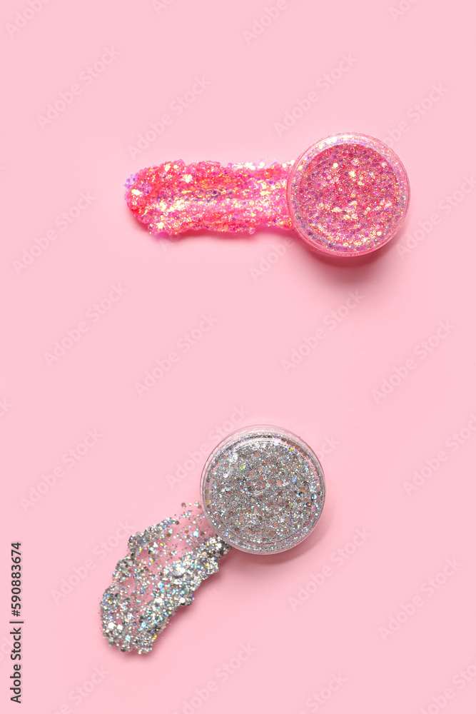 Jars of glitter on pink background