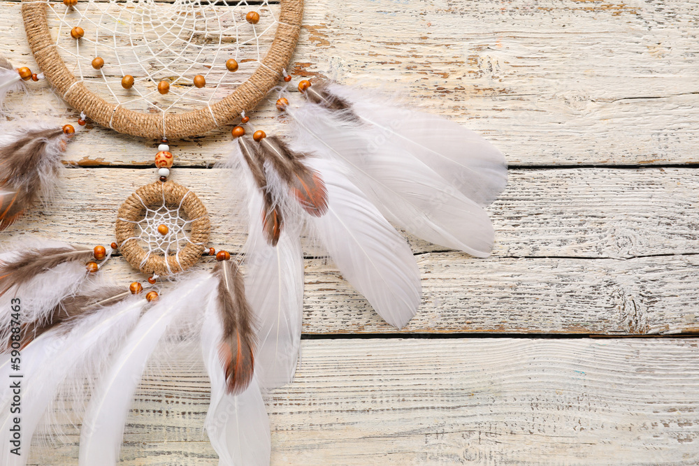 Dream catcher on white wooden background