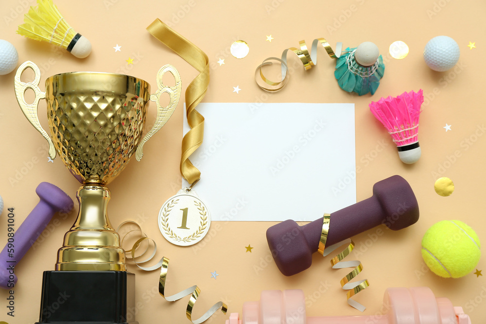 Blank card with gold cup, first place medal and sports equipment on beige background