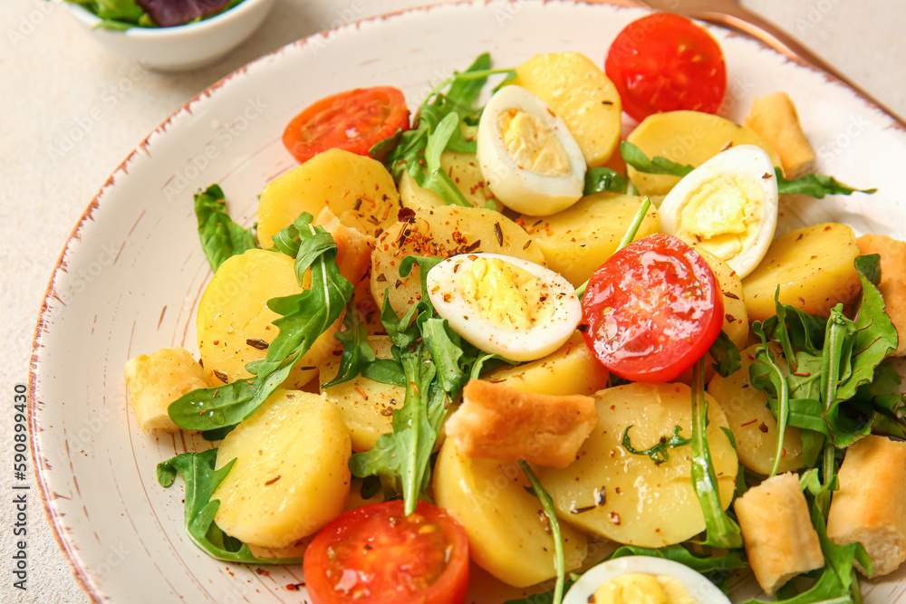 Plate of tasty potato salad with eggs and tomatoes, closeup