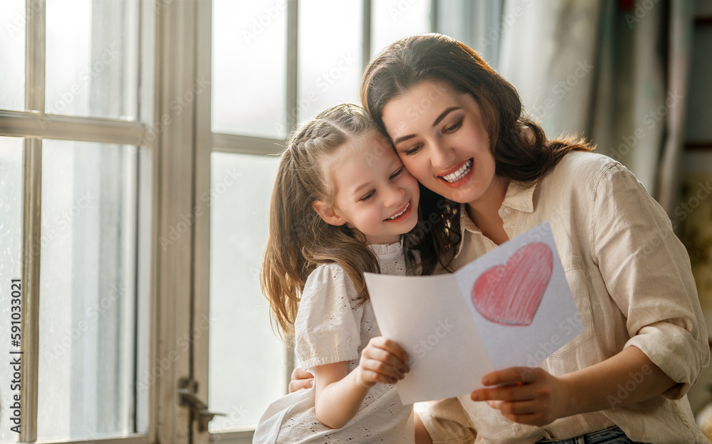 Daughter giving mother postcard.