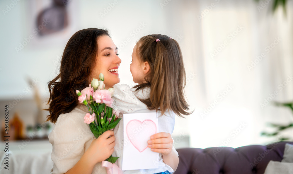 Daughter giving mother bouquet of flowers.