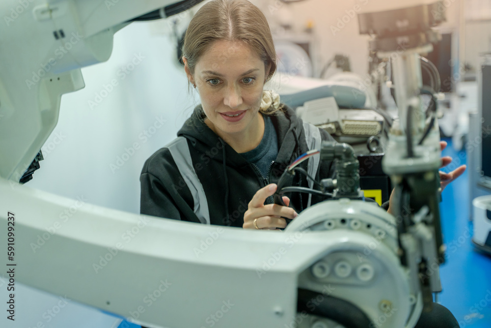 Technical engineer working with adept robotic arm in a workshop,Industrial robot programming softwar