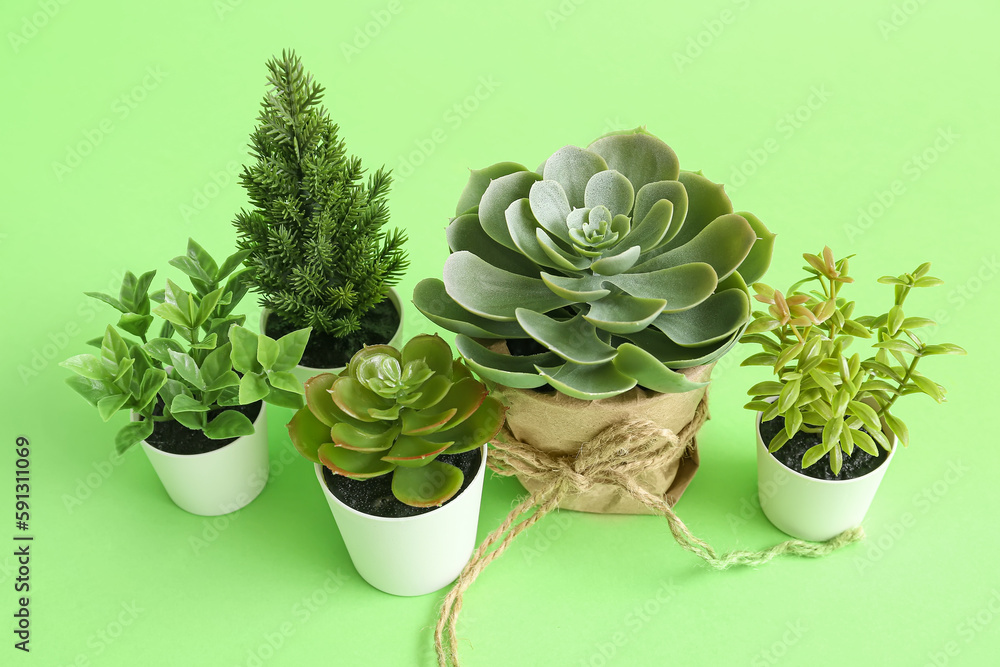 Artificial plants on green background