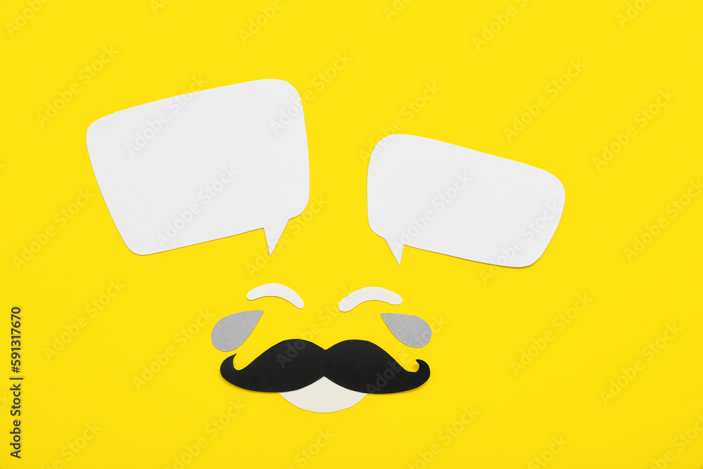 Paper male face with speech bubbles on yellow background. Dialogue concept