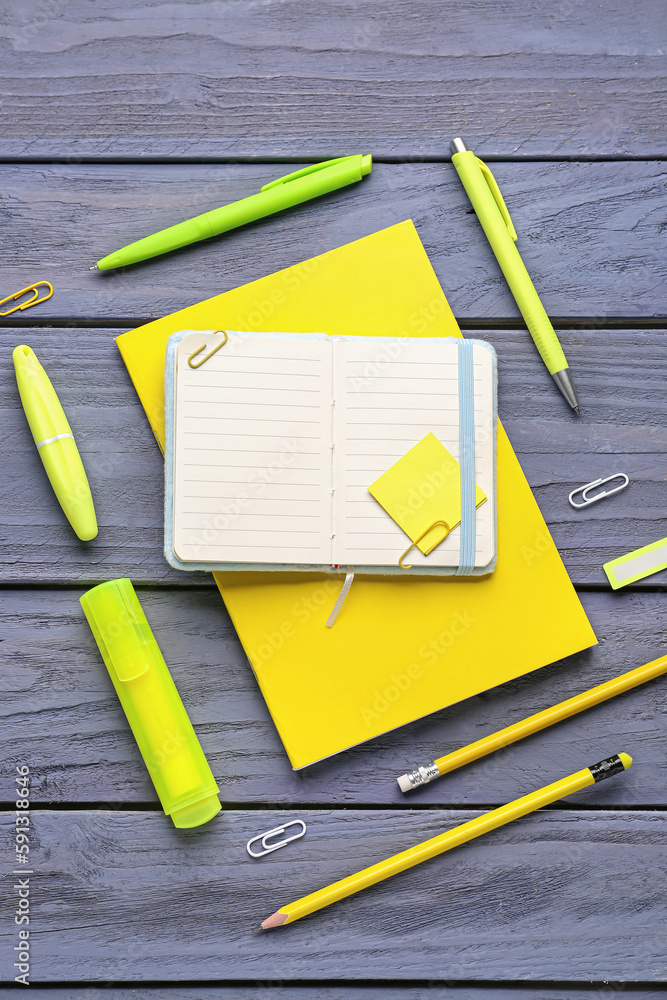 Composition with notepad, sticky note and stationery on blue wooden background