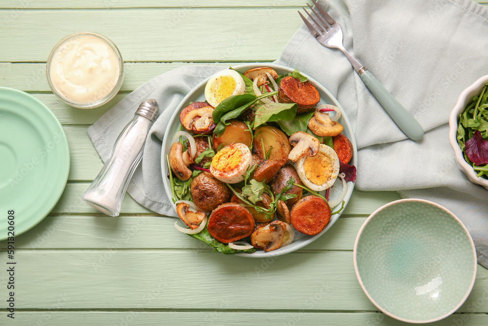 Plate of tasty potato salad with eggs and mushrooms on wooden table, top view