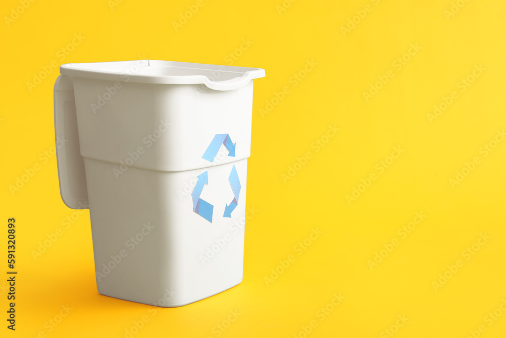 Container for garbage on yellow background. Recycling concept