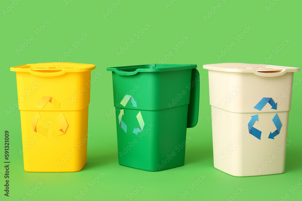 Containers for garbage on green background. Recycling concept