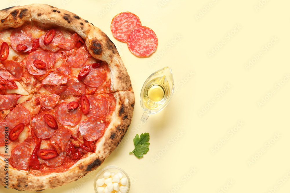 Delicious pepperoni pizza and ingredients on beige background