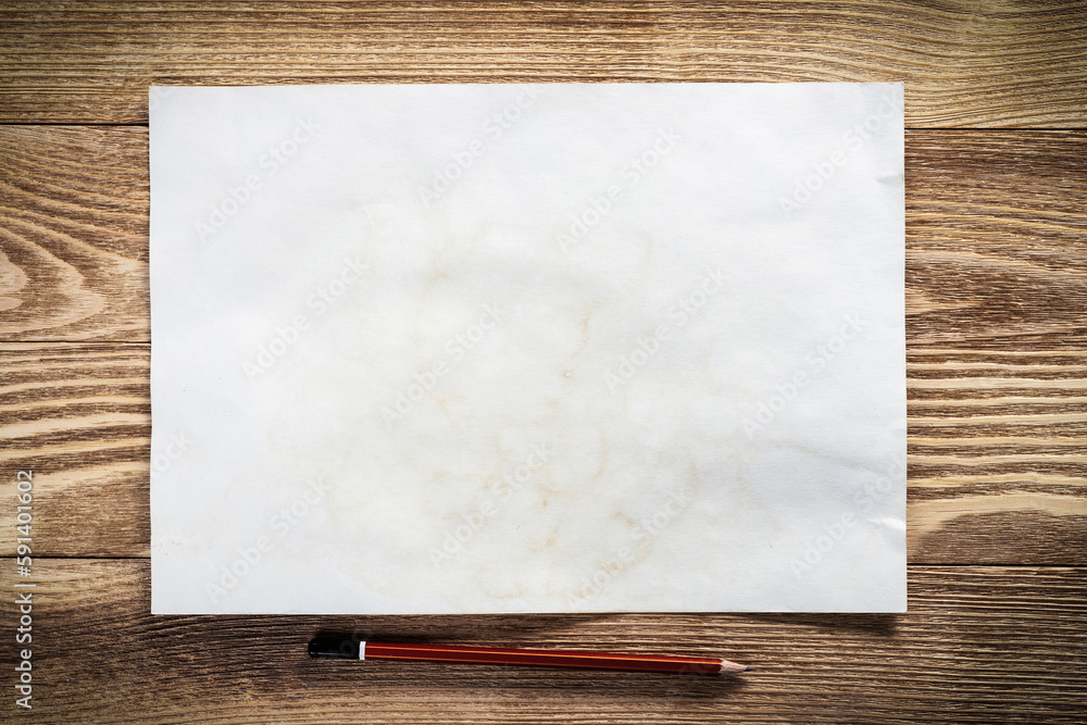 Sheet of paper lying on wooden table