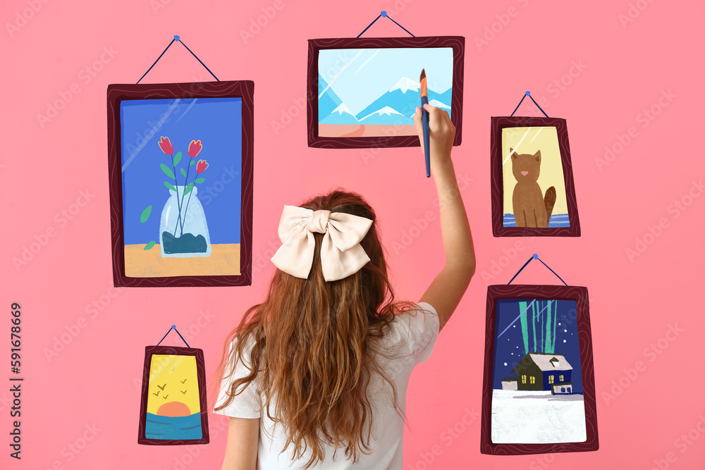 Cute little girl painting pictures on pink background