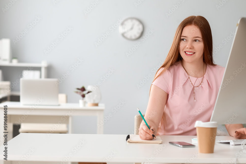 Female programmer working at table in office