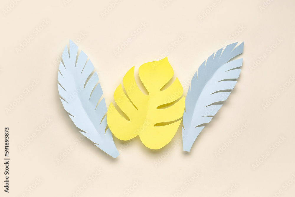 Paper tropical leaves on beige background