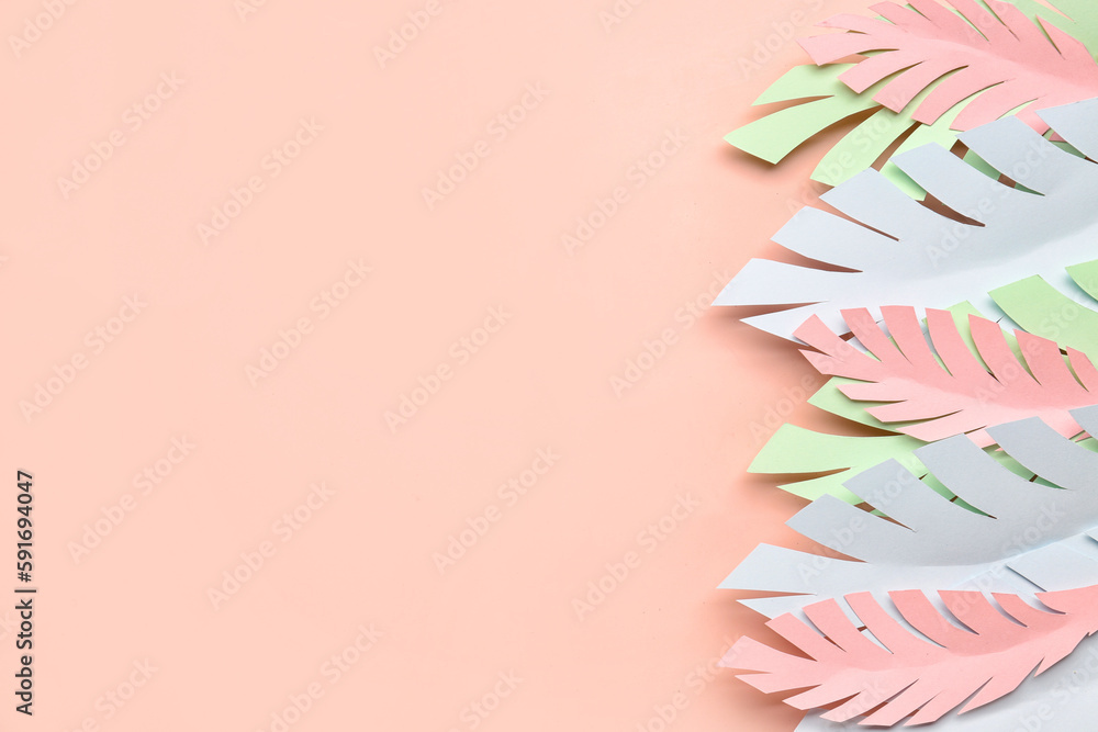 Paper tropical leaves on pink background