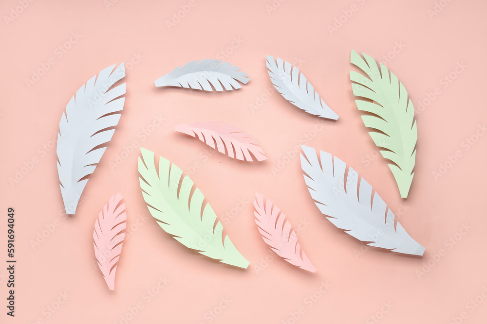 Paper tropical leaves on pink background