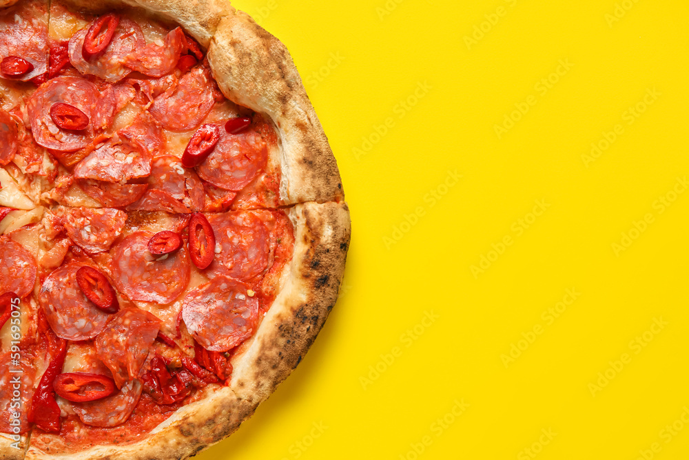 Delicious pepperoni pizza on yellow background