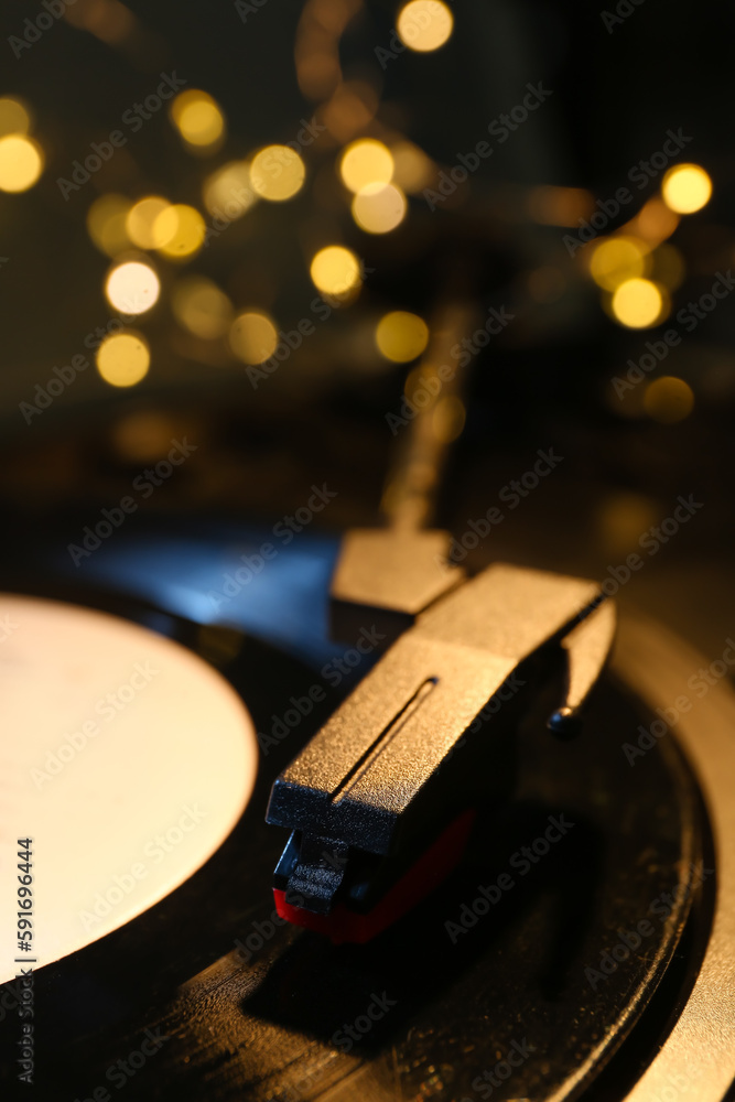 Record player with vinyl disk and glowing lights, closeup