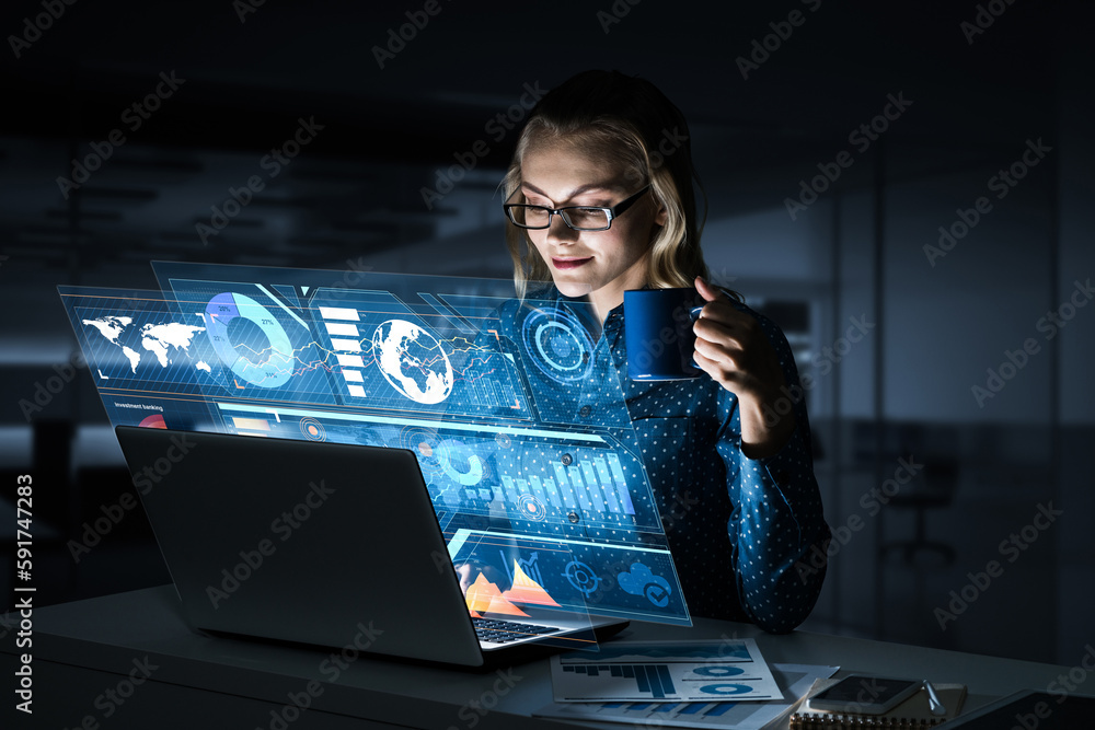 Beautiful blonde working on laptop and infographs out of screen. Mixed media