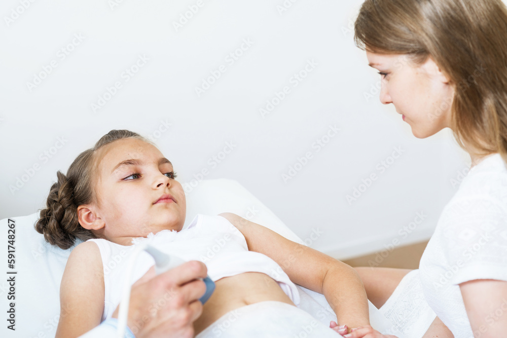 Medical exam little girl by ultrasound equipment