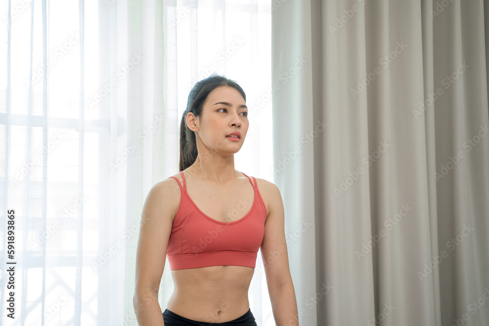 Beautiful woman during her fitness workout at home,Diet concept,Fitness and healthy lifestyle.