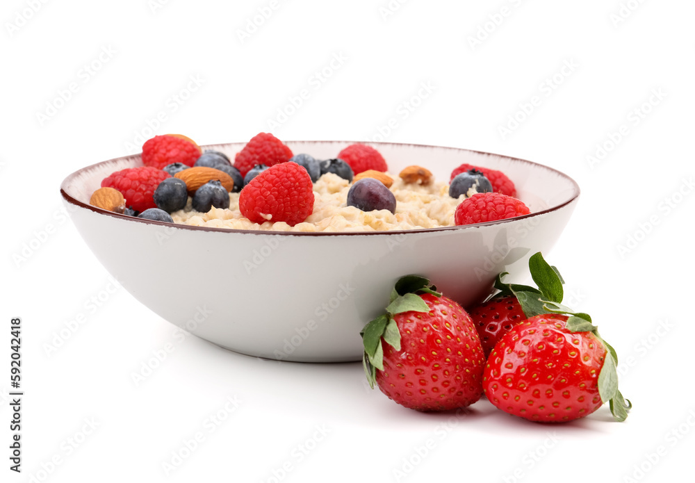 Bowl with tasty oatmeal, ripe berries and almonds isolated on white background