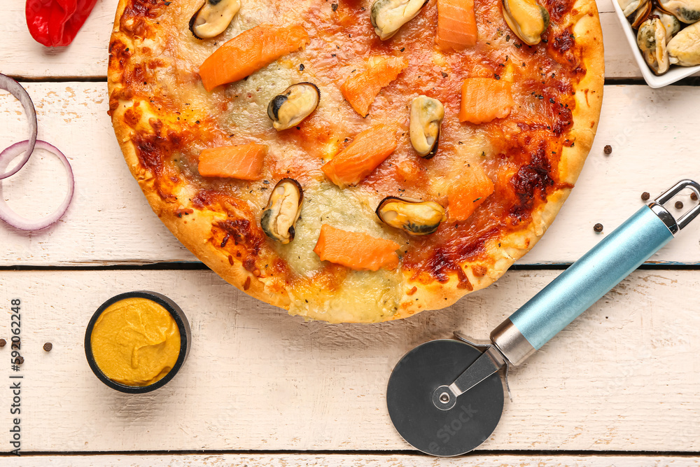 Tasty seafood pizza on light wooden background, closeup