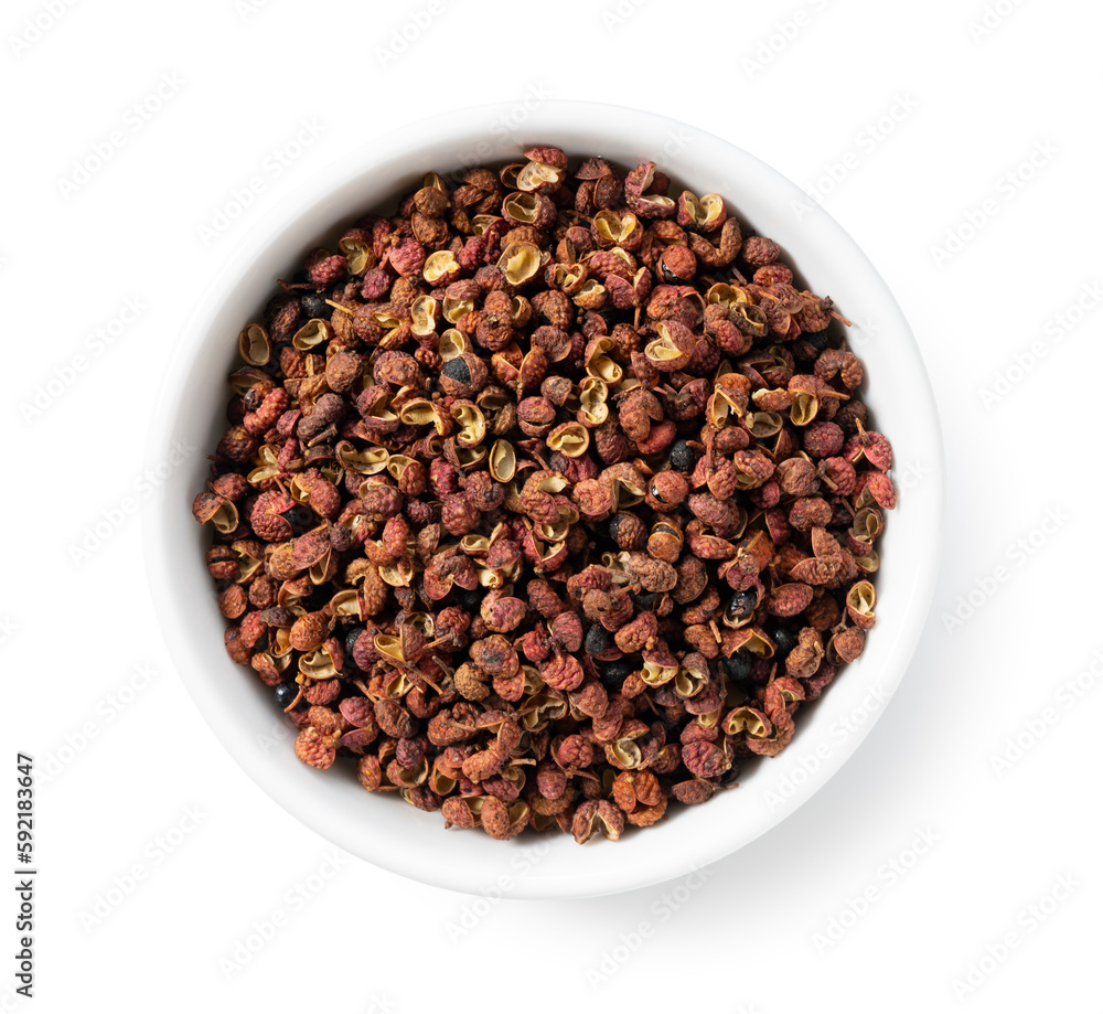 Sichuan pepper in a white bowl set against a white background.