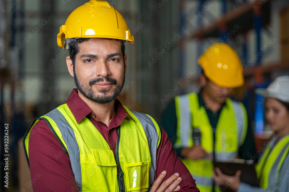 Logistics worker storing package boxes in a large distribution centre,Warehouse worker moving cardbo