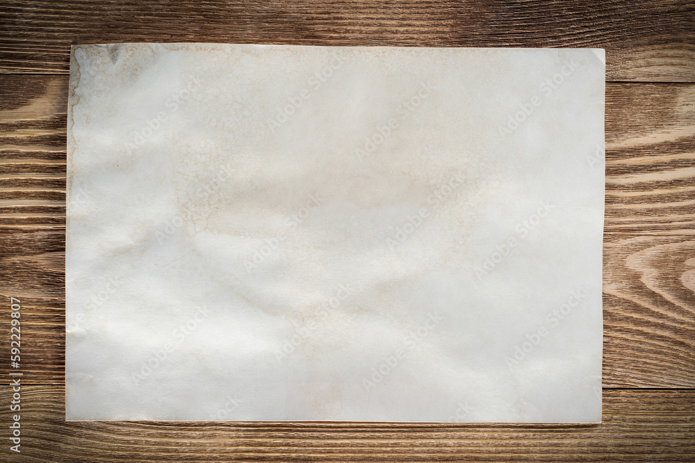 Sheet of paper lying on wooden table