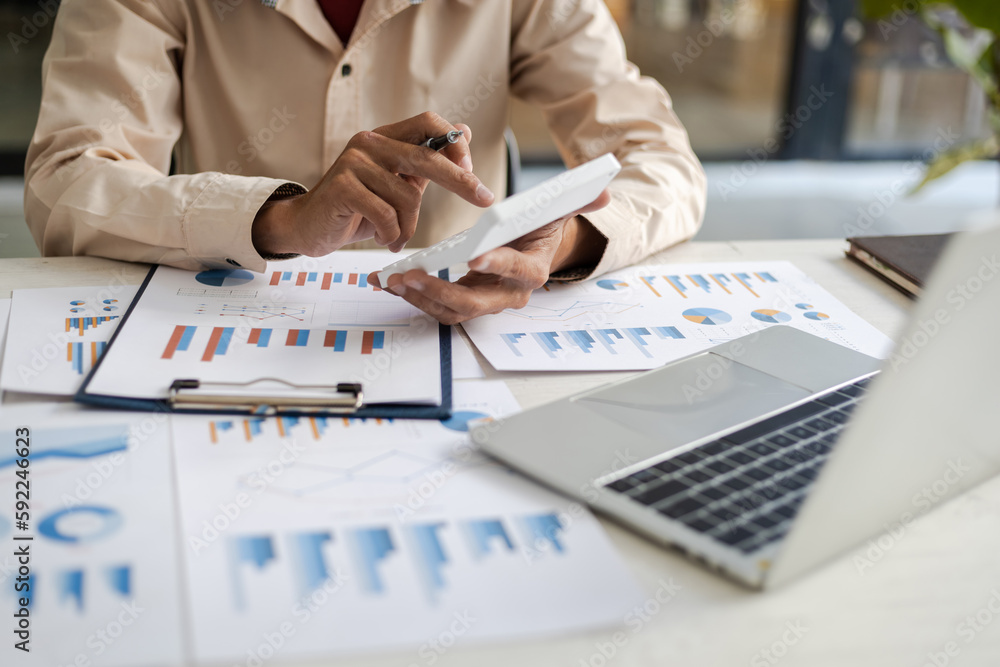 Businessman pointing at financial chart document and statistical market growth analysis. Accounting 