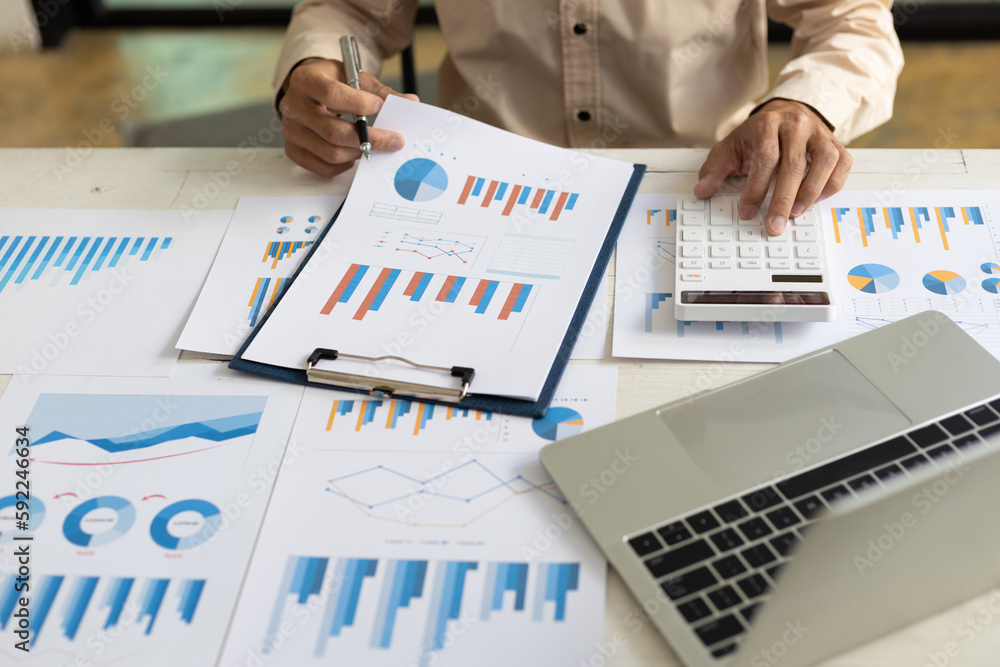 Businessman pointing at financial chart document and statistical market growth analysis. Accounting 