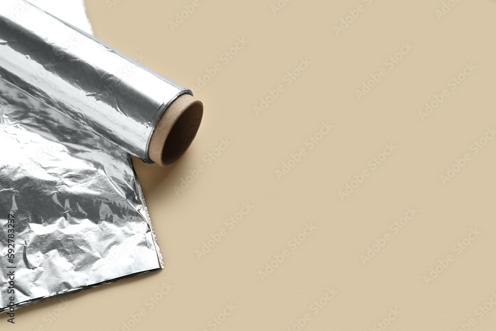 Aluminium foil roll on color background