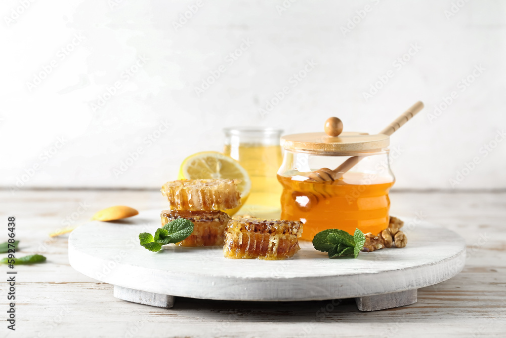 Jar of sweet honey and combs on table