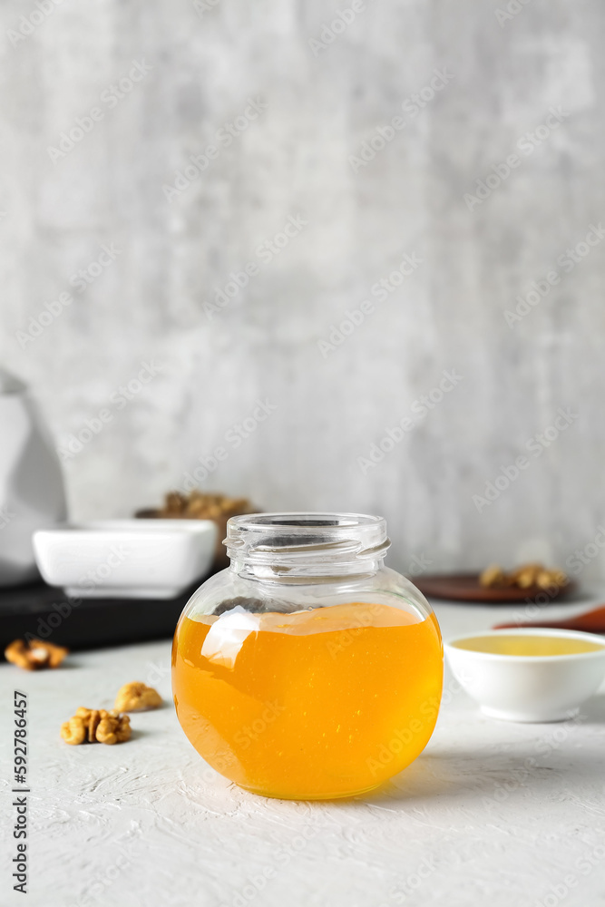 Jar of sweet honey on table