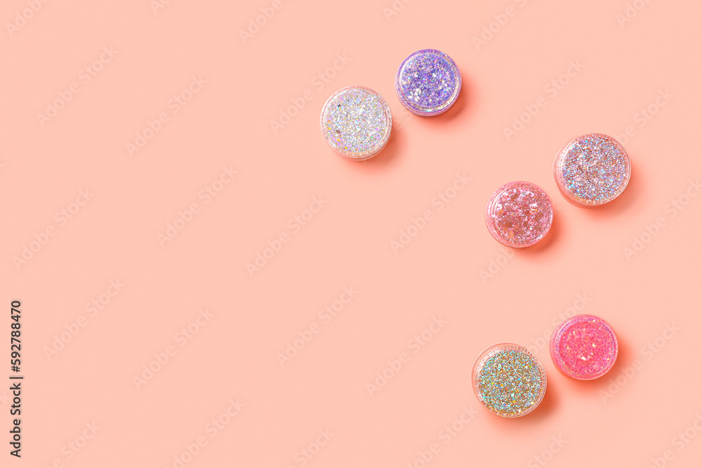 Jars of glitter on pink background