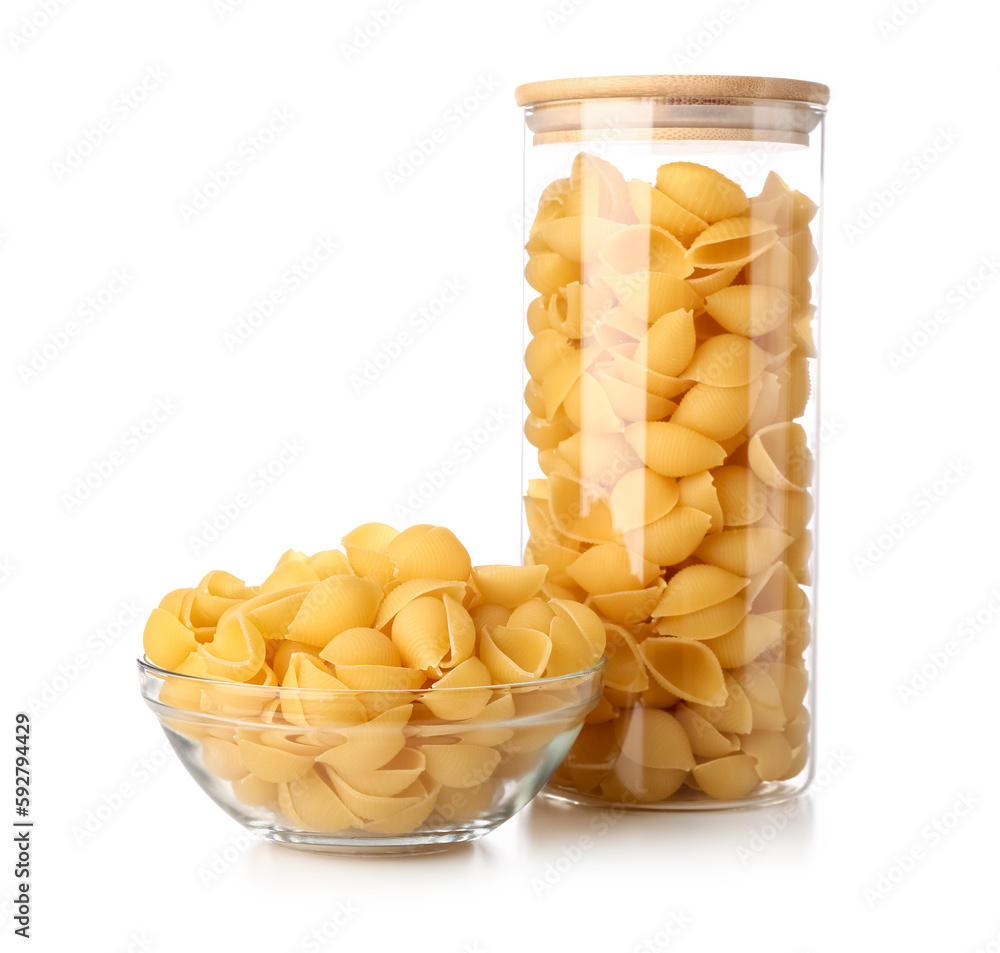 Jar and bowl of raw conchiglie pasta isolated on white background