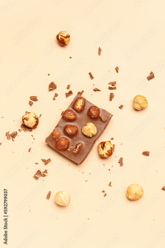 Sweet tasty chocolate with nuts on  beige background