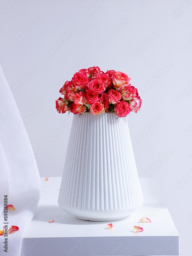 Beautiful bouquet of pink roses in a white vase