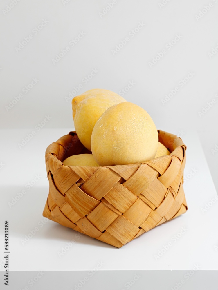 Closeup of beautiful yellow peaches on a small basket