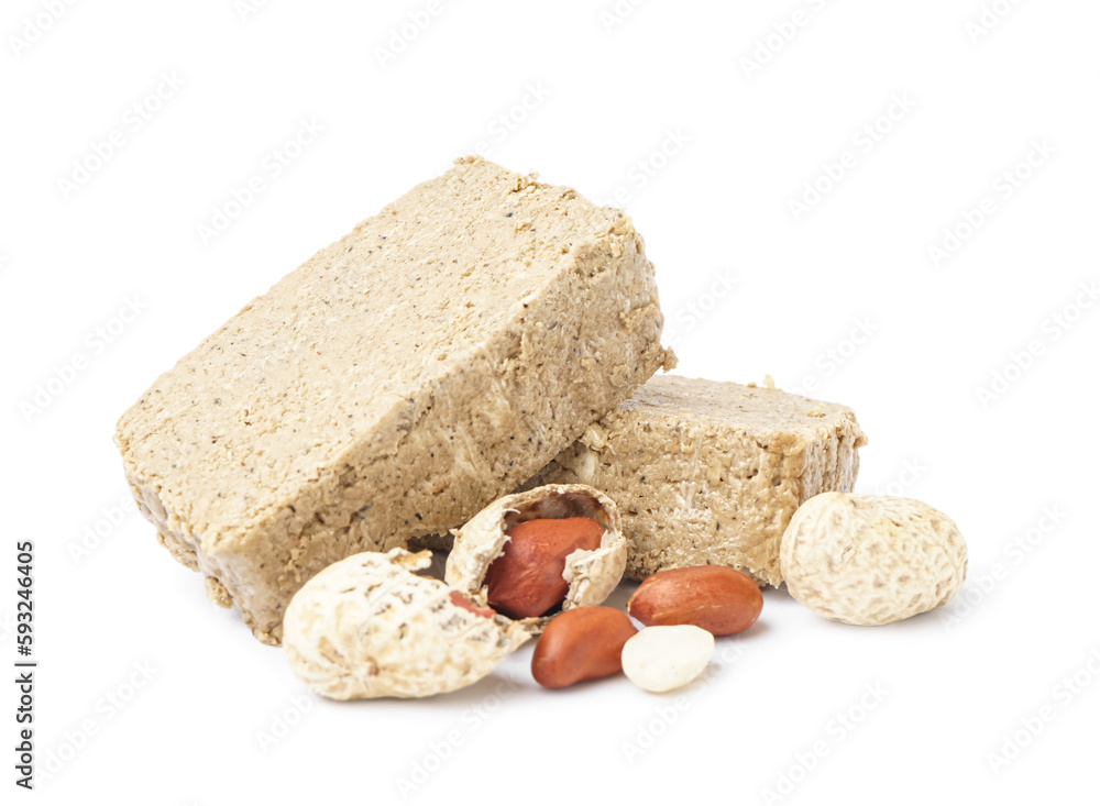 Pieces of sweet halva and peanuts on white background