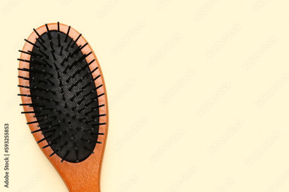 Hair brush on beige background