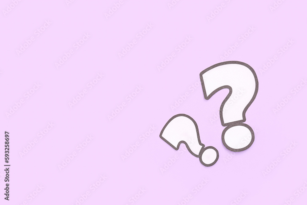 Paper question marks on lilac background