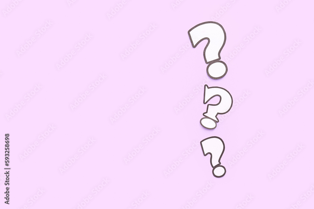 Paper question marks on lilac background