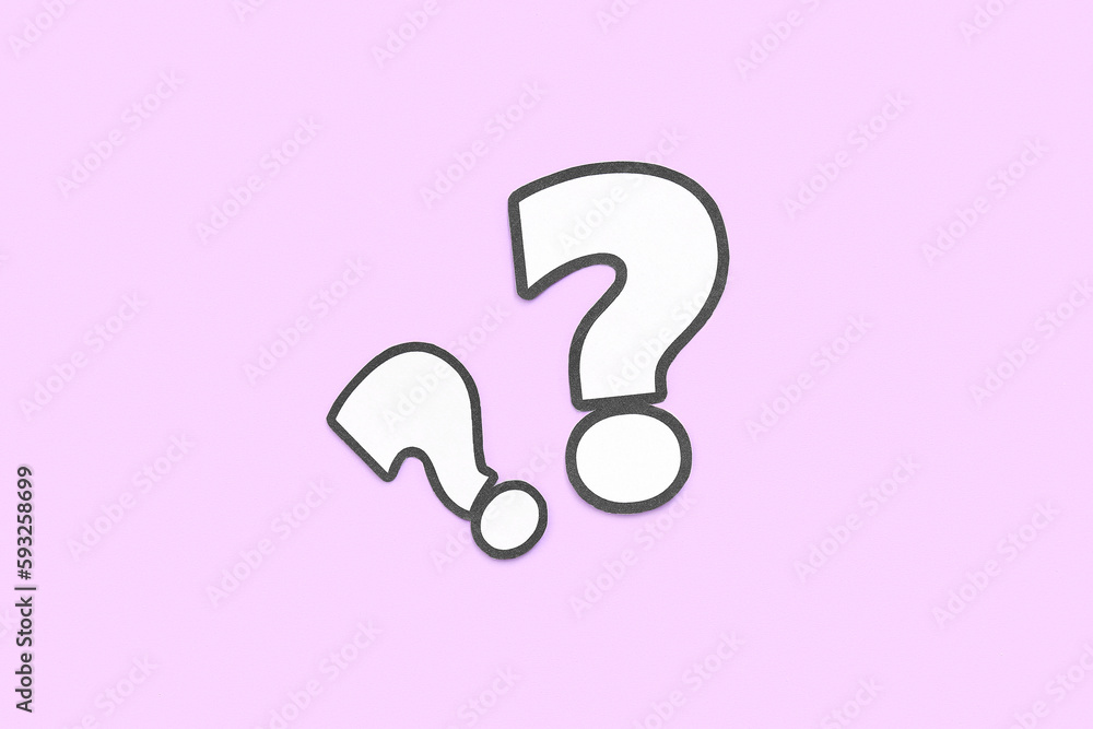 Paper question marks on lilac background