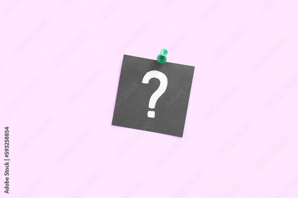 Pinned paper with question mark on pink background