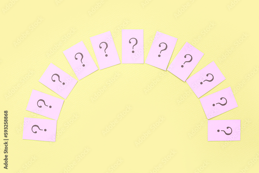 Papers with question marks on yellow background